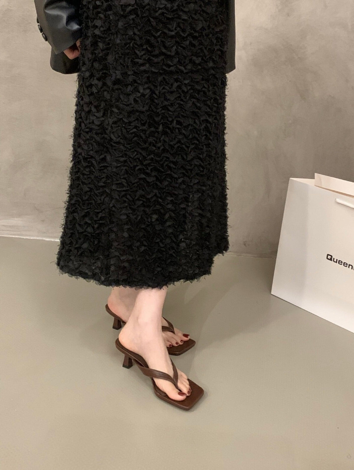 Brown Camille kitten heel sandals worn with a black skirt
