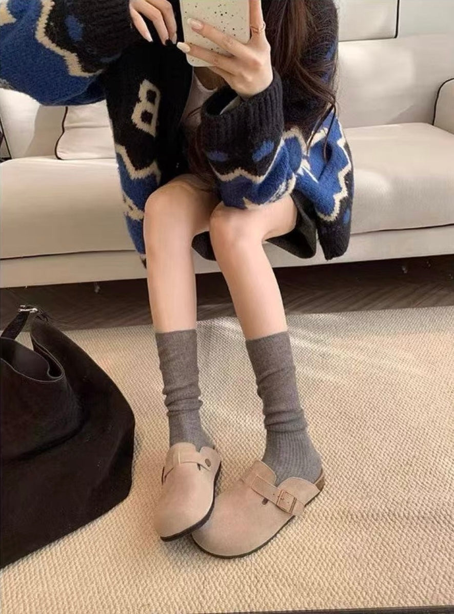 Maren Leather Buckle Mules in Dark Taupe, seated styling with socks