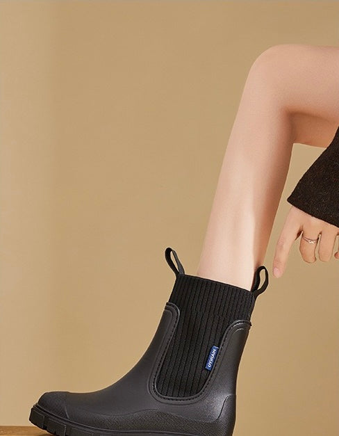 Mira Mid-Calf Rain Boots in Black, side view on foot