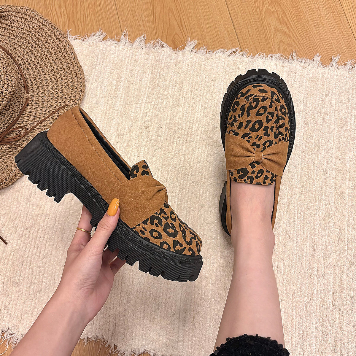 Brown leopard-print bow platform loafers styled on foot